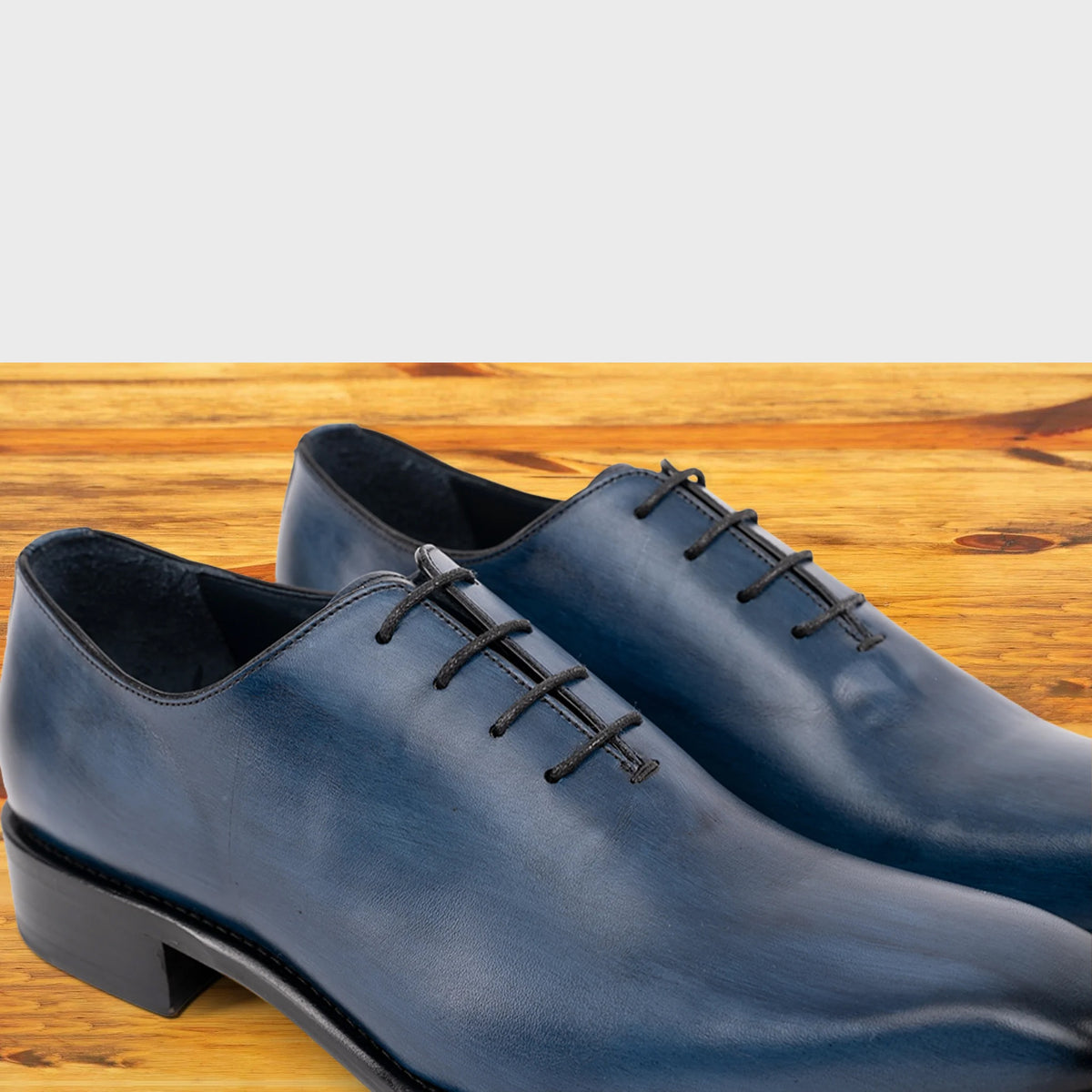 Pair of Ocean Blue leather dress shoe on a wooden surface