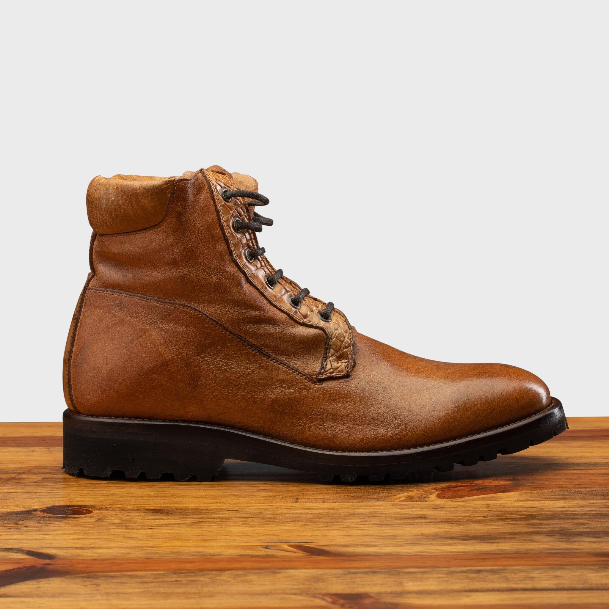 Side profile of the 3236 Calzoleria Toscana Brick Shearling Boot on top of a wooden table