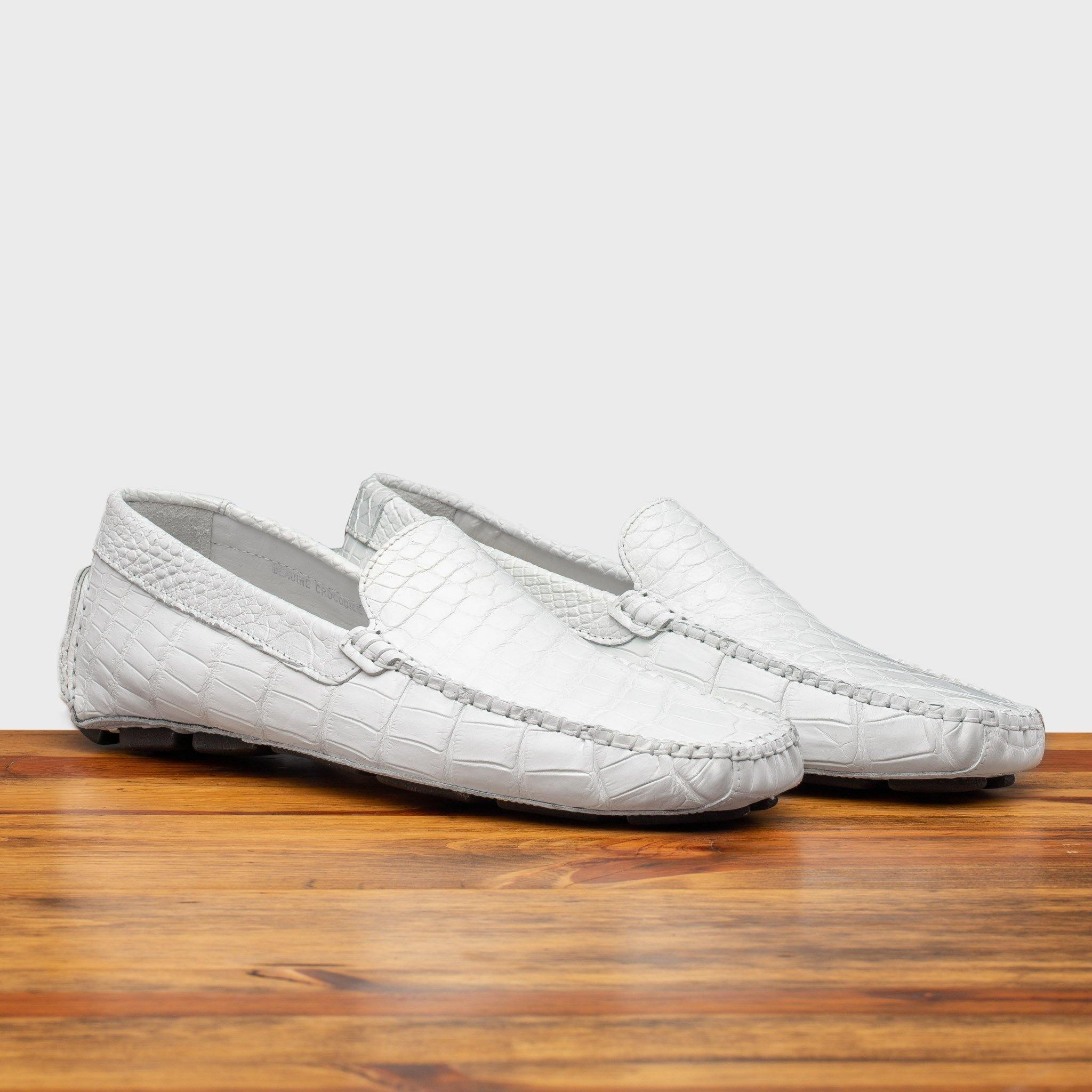 Pair of 4551 Calzoleria Toscana White Crocodile Dip-Dyed Driver on top of a wooden table