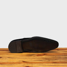 Full leather outsole of 4870 Calzoleria Toscana Burgundy David Wholecut on top of a wooden table