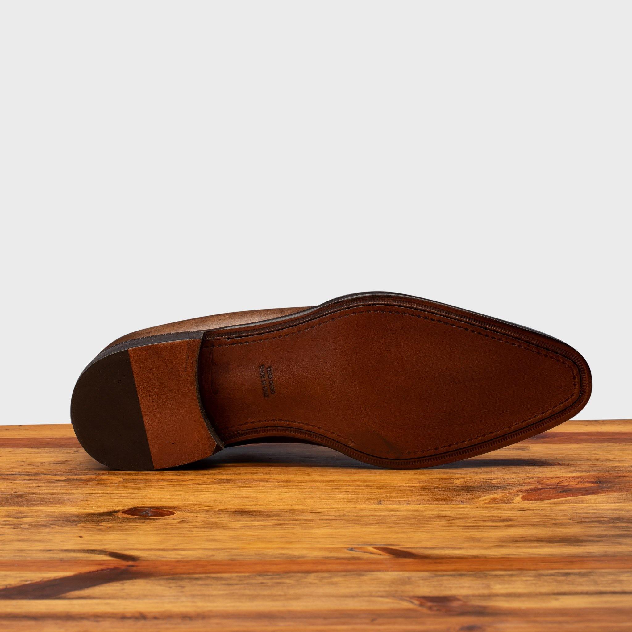 Full leather outsole of 5246 Calzoleria Toscana Cerris Wholecut Lace-up on top of a wooden table