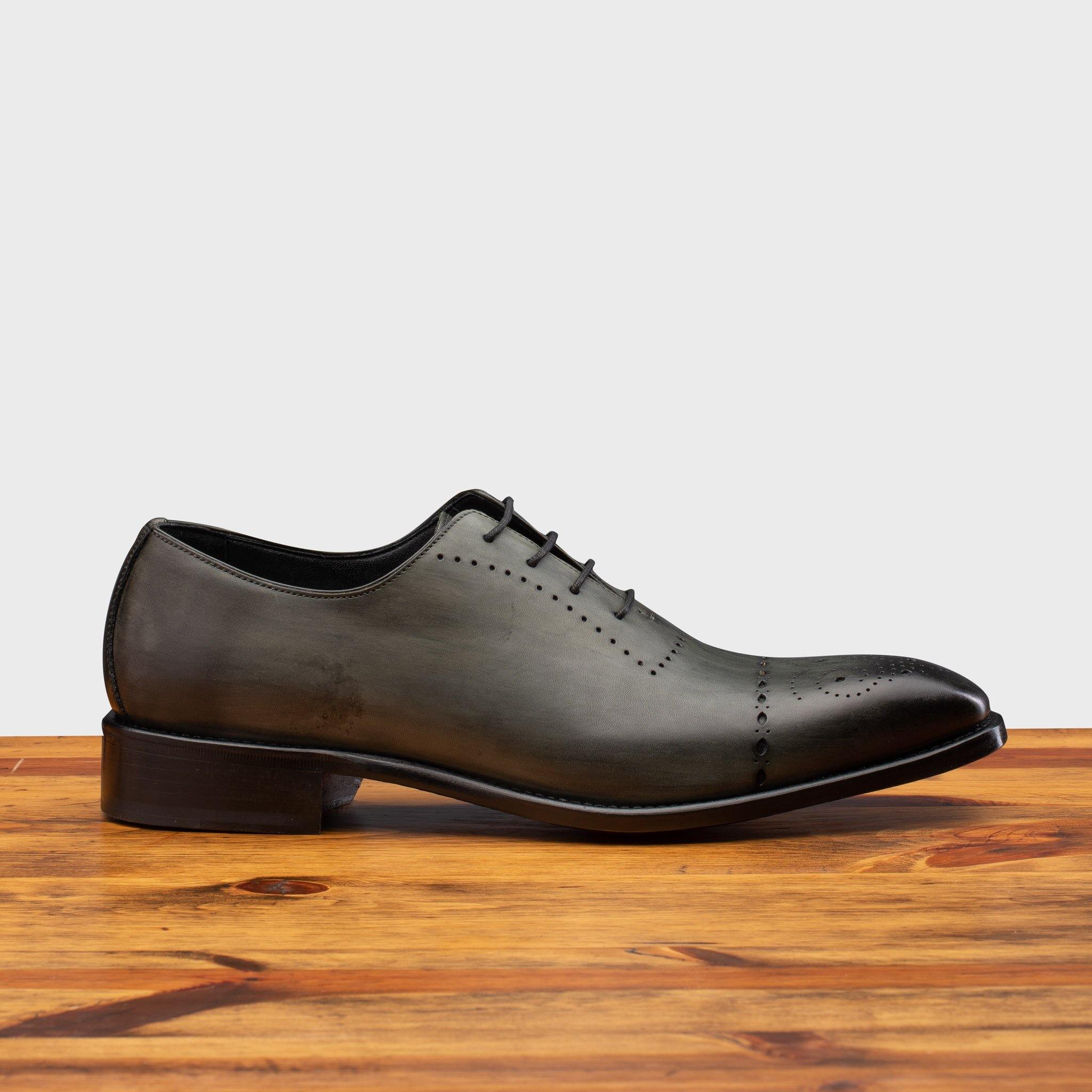 Side profile of 5246 Calzoleria Toscana Emerald Green Wholecut Lace-up on top of a wooden table