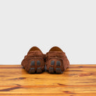 Back profile of 5303 Calzoleria Toscana Brick Venetian Suede Driver on top of a wooden table