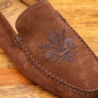 Up close picture of the tone on tone embroidered fleur de lis on 5303 Calzoleria Toscana Brick Venetian Suede Driver