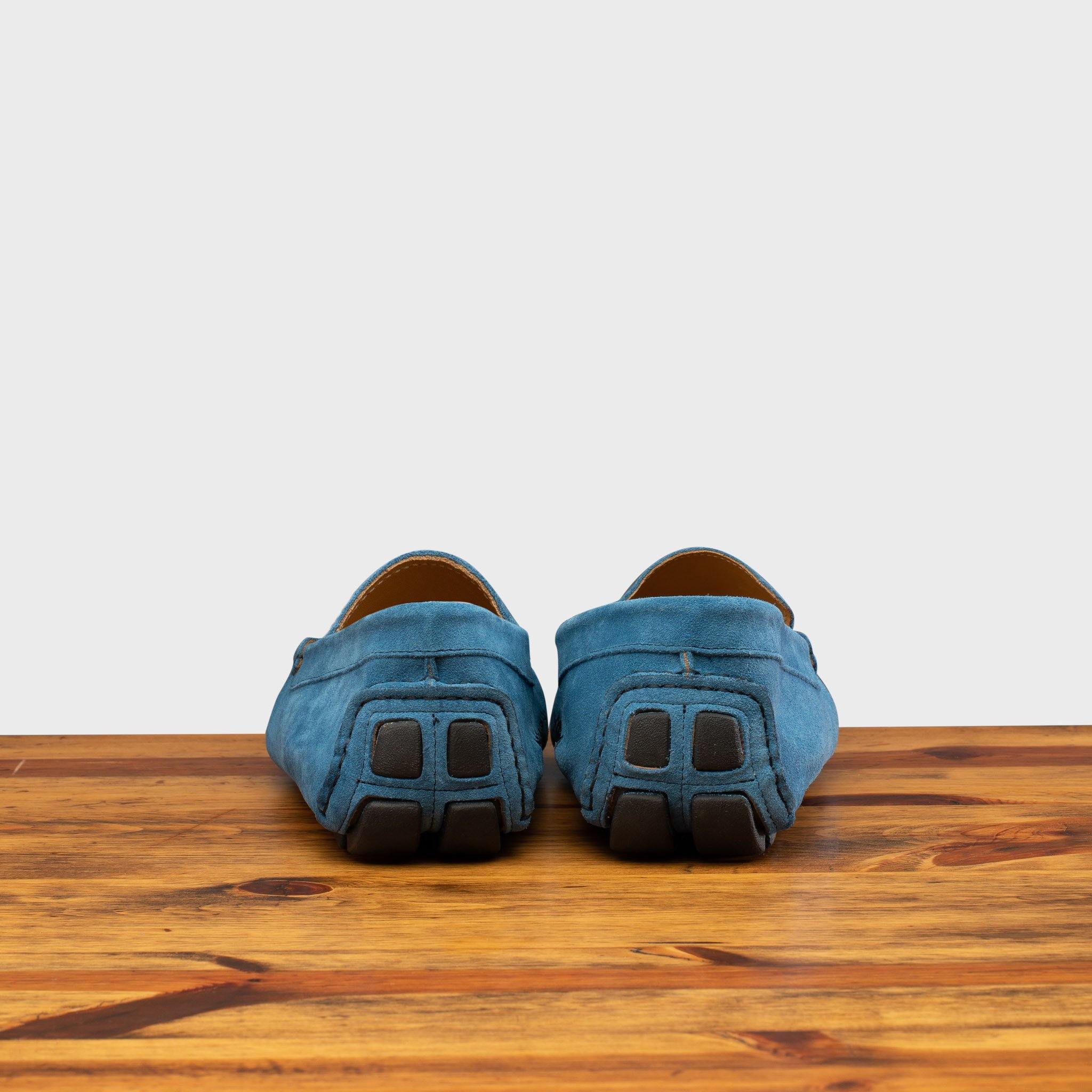 Back profile of 5303 Calzoleria Toscana Denim Blue Venetian Suede Driver on top of a wooden table