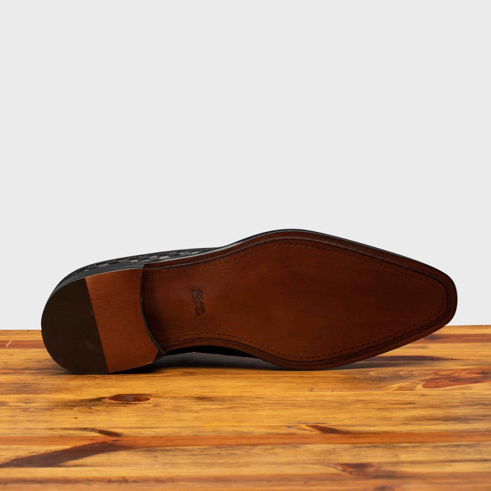 Full leather outsole of 5373 Calzoleria Toscana Black Woven Lace-Up on top of a wooden table