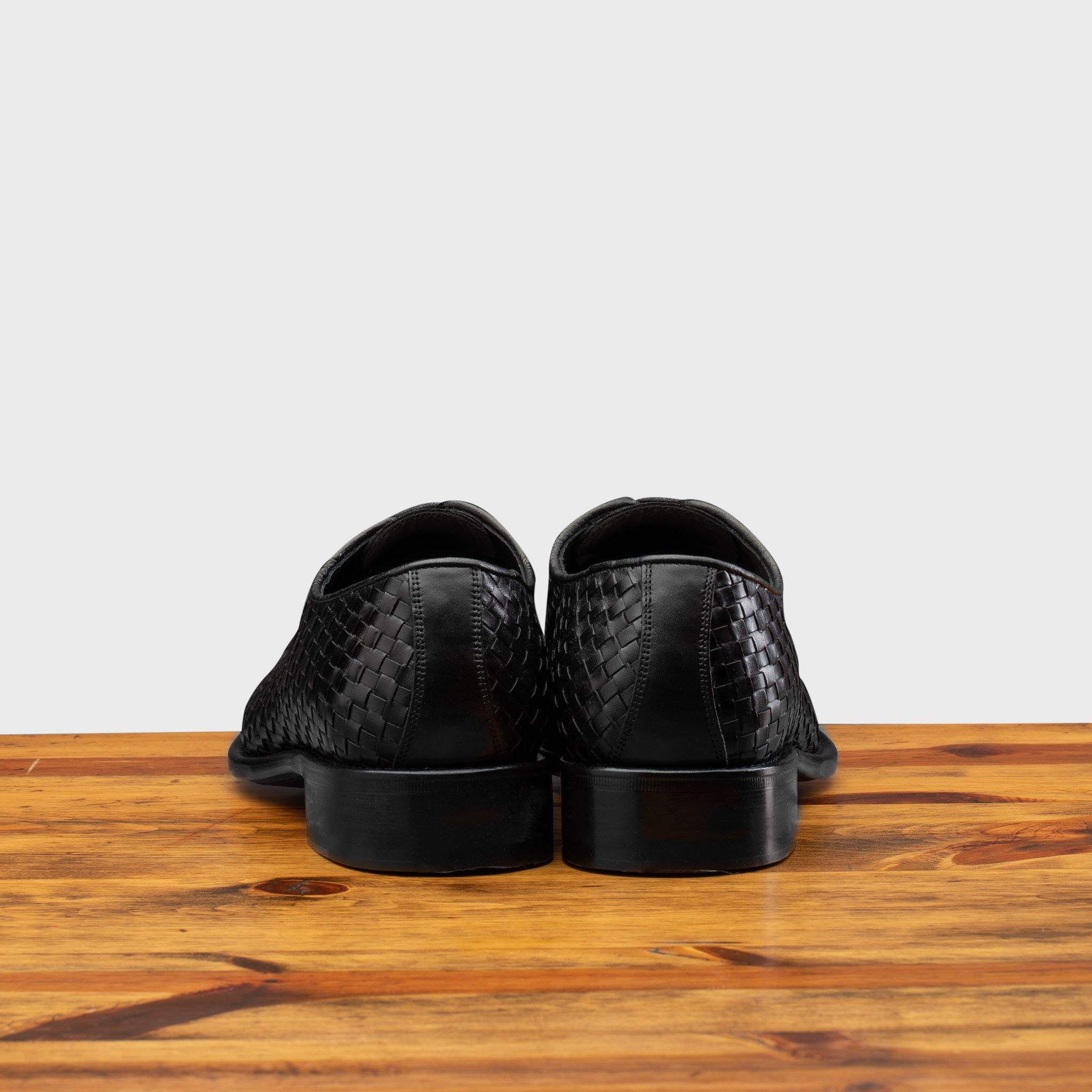 Back profile of 5373 Calzoleria Toscana Black Woven Lace-up on top of a wooden table