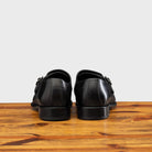 Back profile of 6582 Calzoleria Toscana Black Monkstrap Cap Toe on top of a wooden table