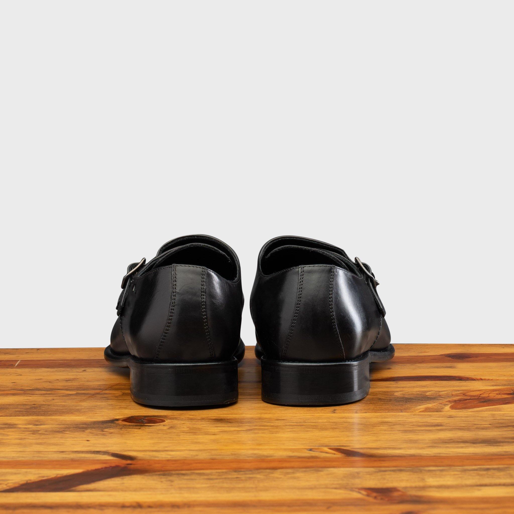Back profile of 6582 Calzoleria Toscana Black Monkstrap Cap Toe on top of a wooden table