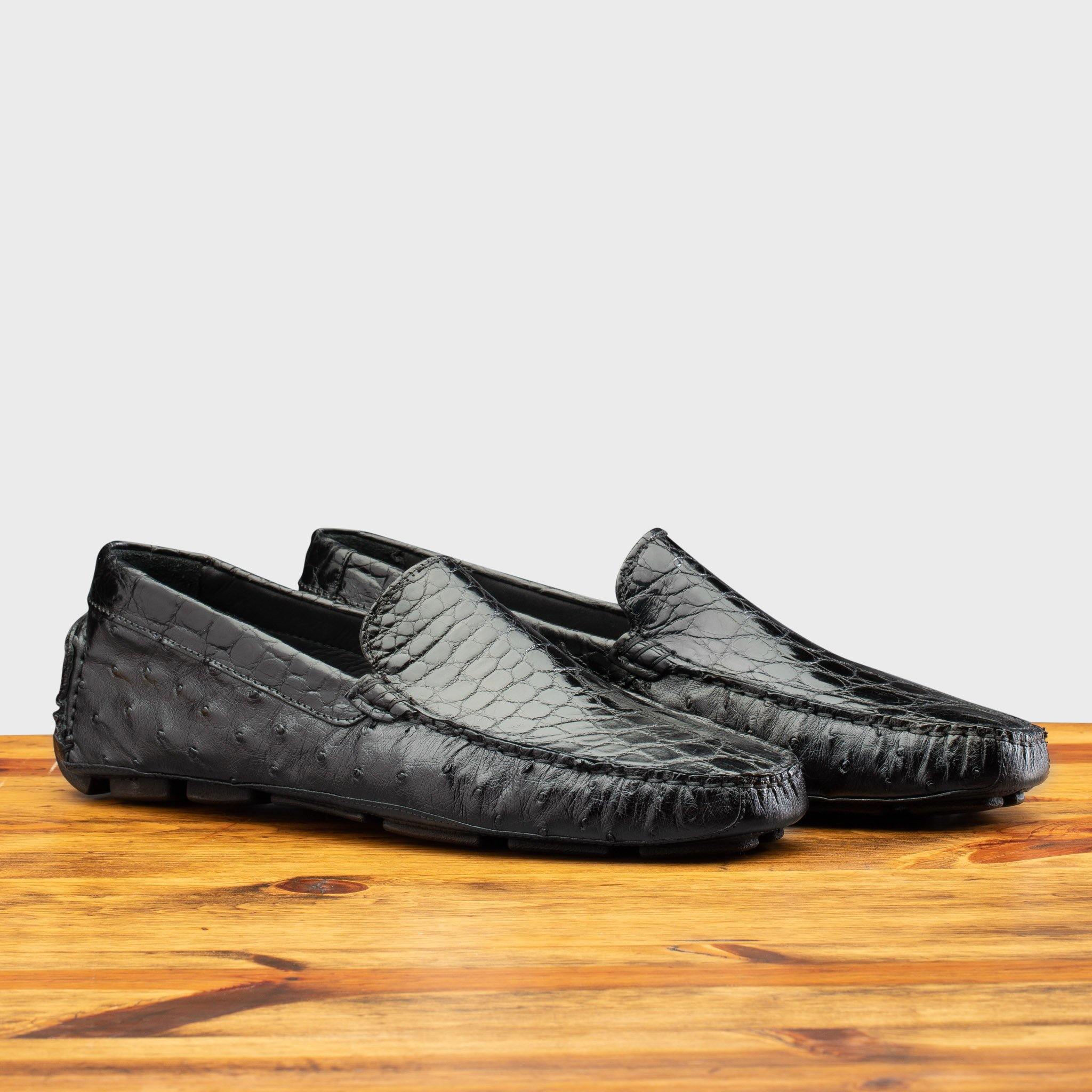 Pair of 8675 Calzoleria Toscana Blue Ostrich and Alligator Driver on top of a wooden table