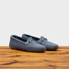 Pair of 8976 Calzoleria Toscana Women's Jean Blue Suede Driver on top of a wooden table