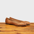 Pair of B940 Calzoleria Toscana Brick Melania Ballerina on top of a wooden table