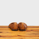 Back profile of B940 Calzoleria Toscana Brick Melania Ballerina on top of a wooden table