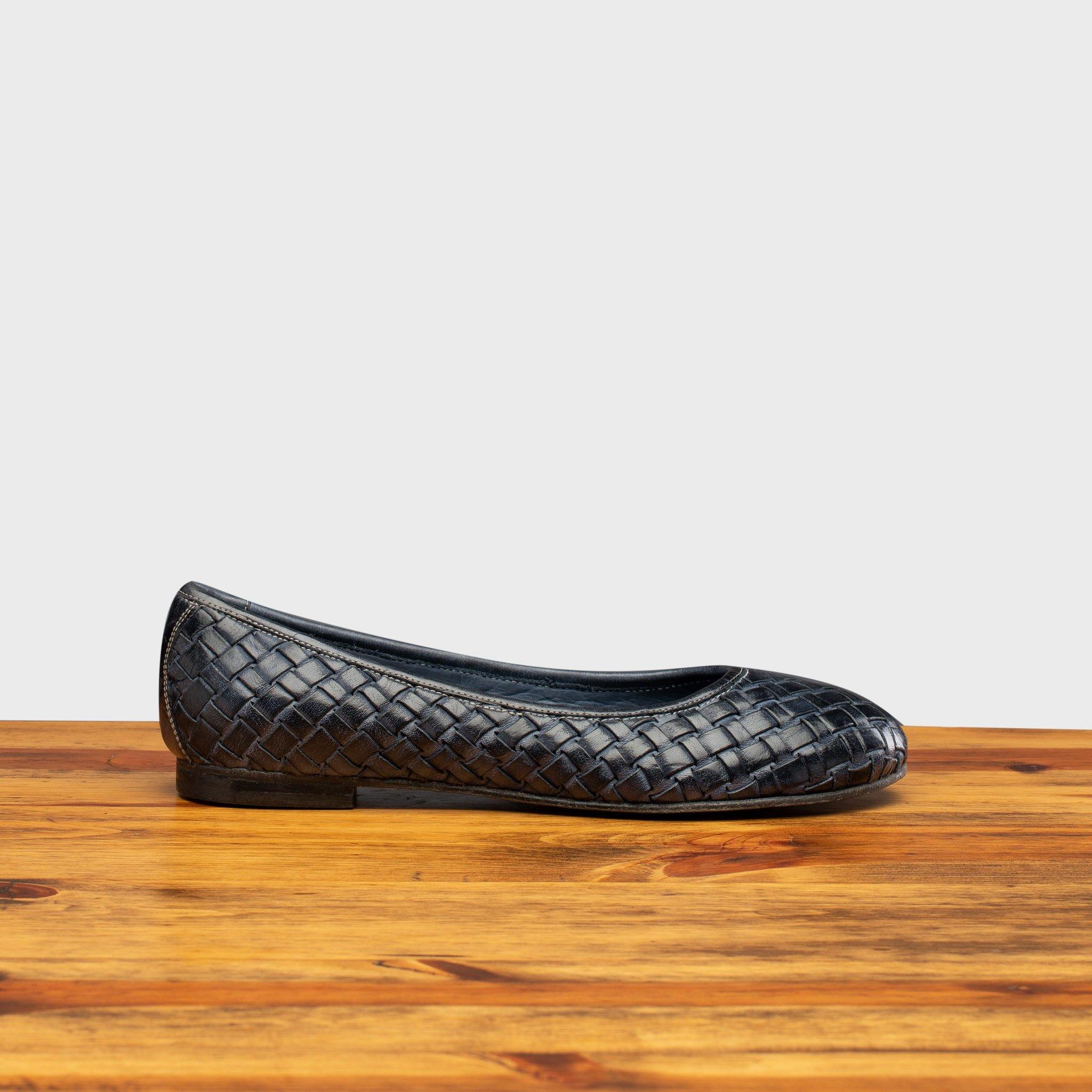 Side profile of B940 Calzoleria Toscana Navy Woven Melania Ballerina on top of a wooden table