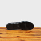 Full leather outsole of B940 Calzoleria Toscana Navy Melania Ballerina on top of a wooden table