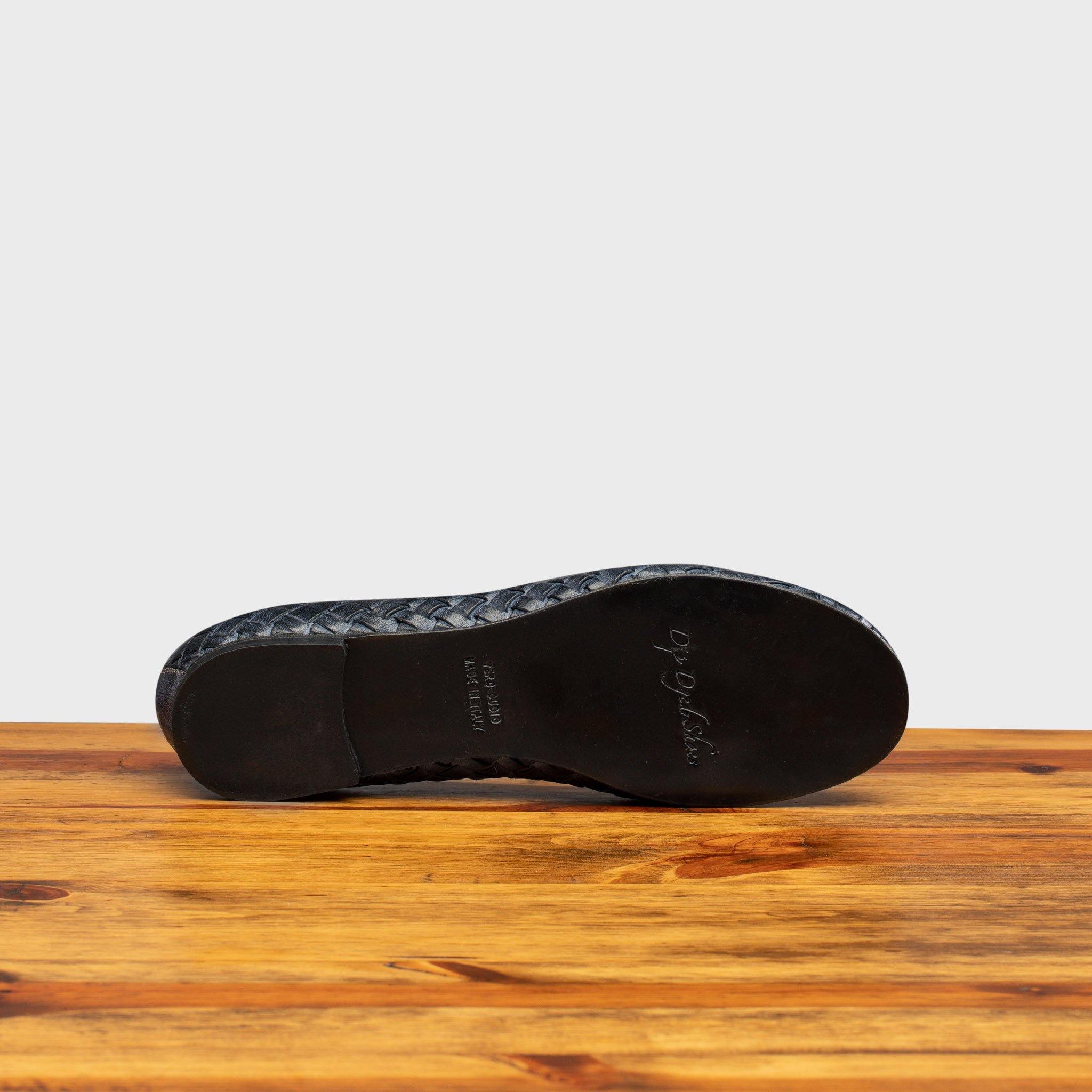 Full leather outsole of B940 Calzoleria Toscana Navy Melania Ballerina on top of a wooden table
