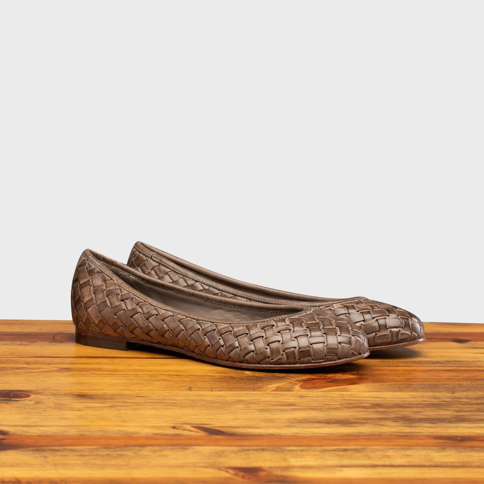 Pair of B940 Calzoleria Toscana Taupe Woven Melania Ballerina on top of a wooden table