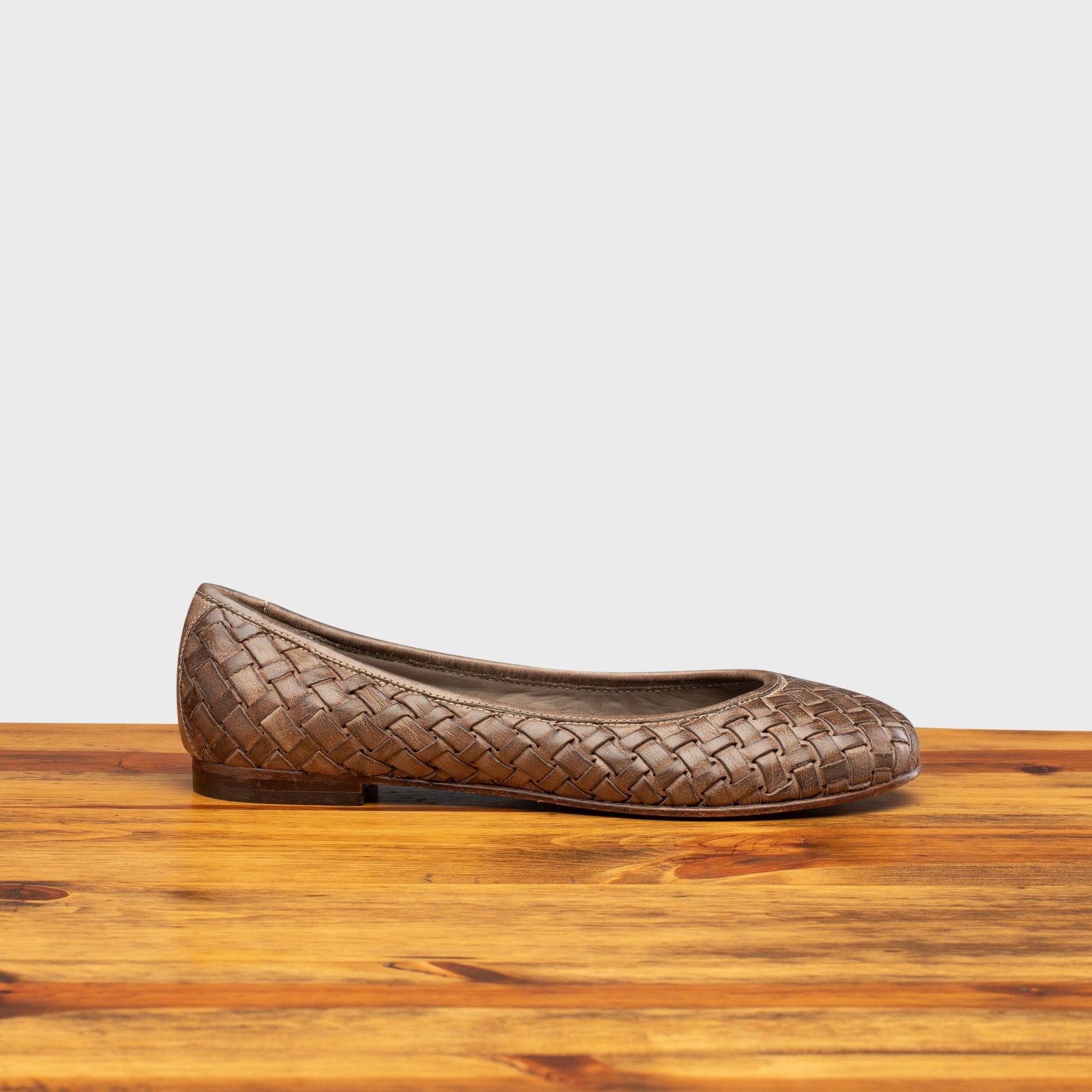 Side profile of B940 Calzoleria Toscana Taupe Woven Melania Ballerina on top of a wooden table
