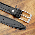 Up close picture of C2216 Calzoleria Toscana Black Inner Stitched Dress Belt on top of a wooden table