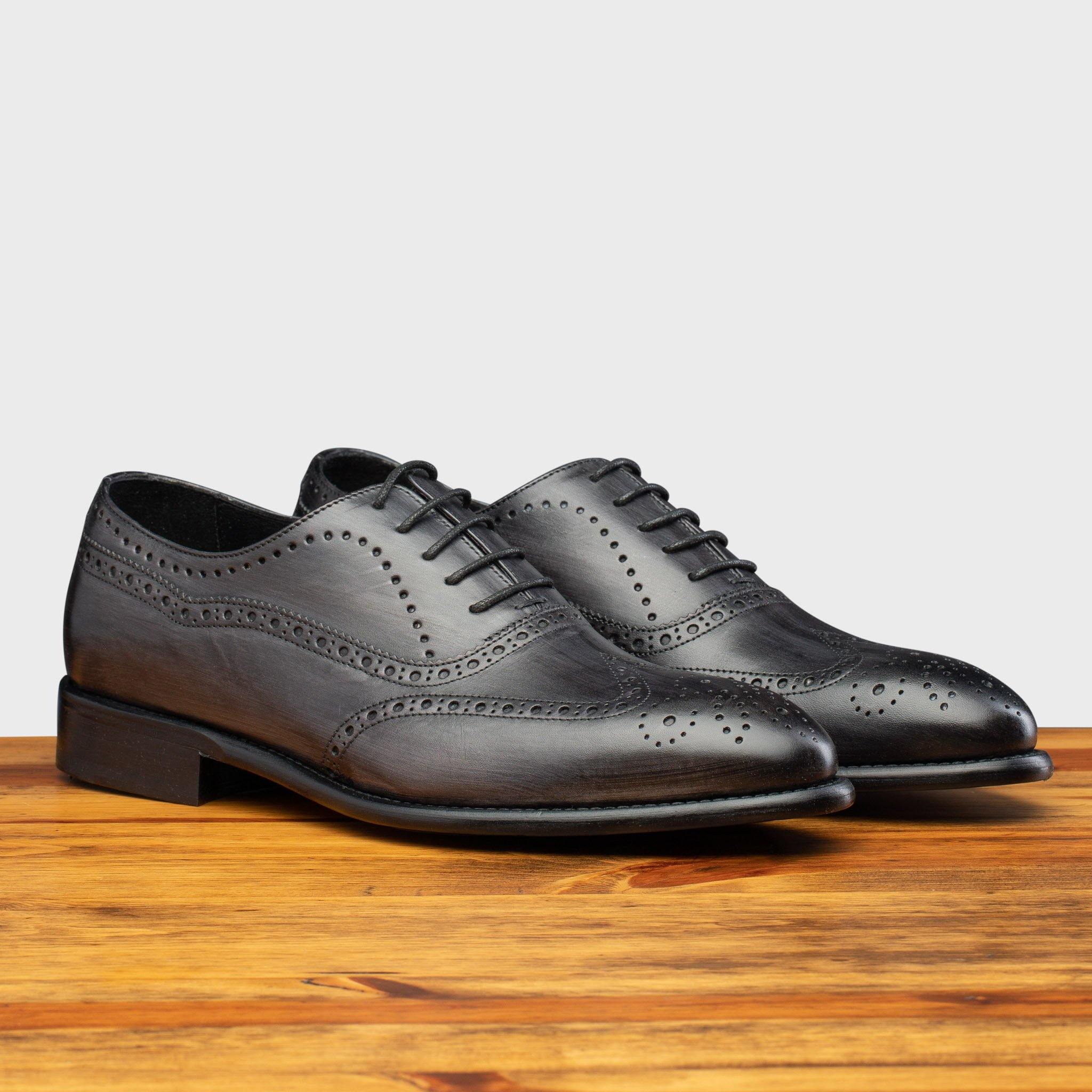 Pair of H742 Calzoleria Toscana Gray Balmoral Lace-up on top of a wooden table