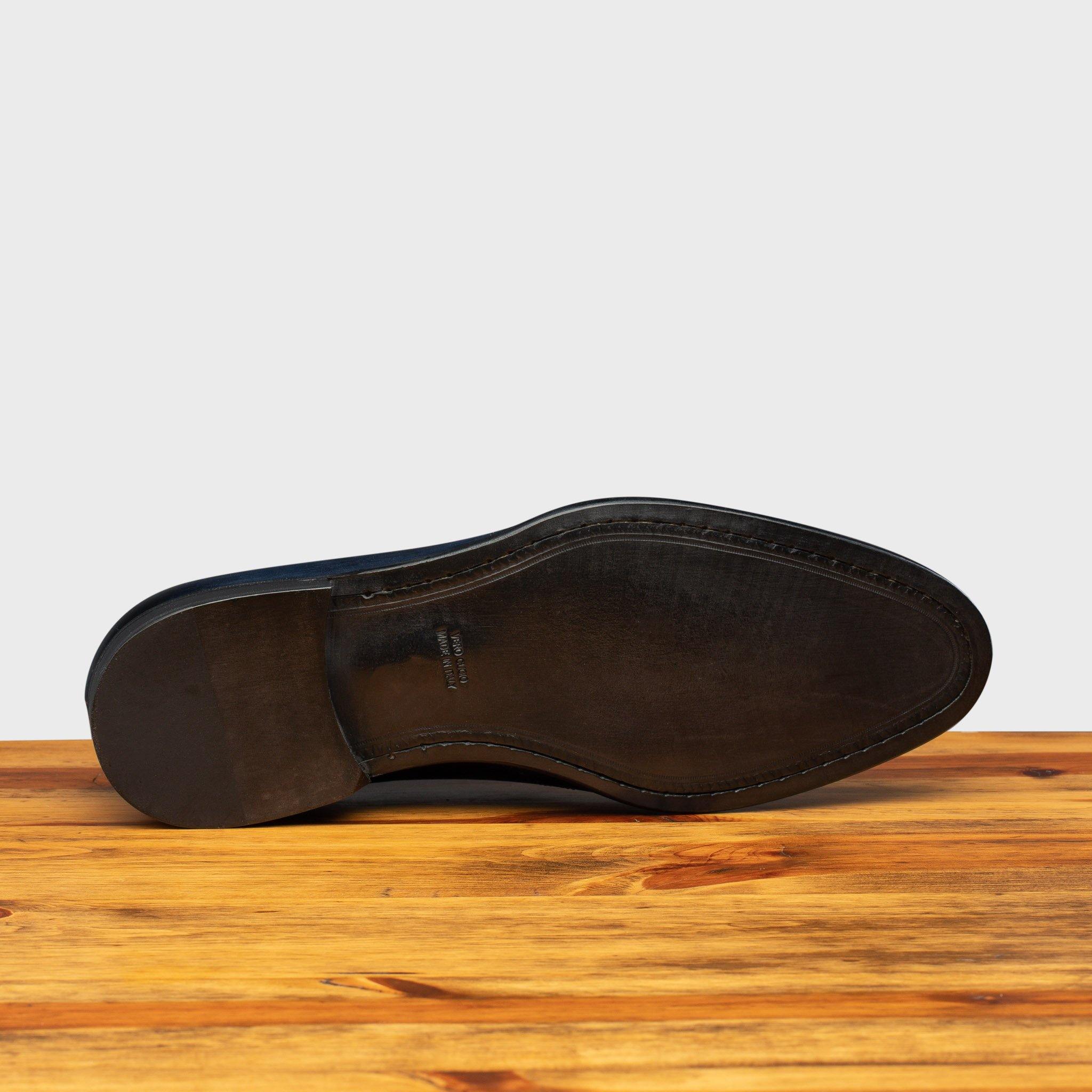 Full leather outsole of H742 Calzoleria Toscana Blue Balmoral Lace-up on top of a wooden table