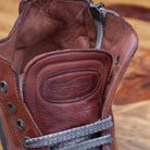 Up close picture showing the tongue stamped with the brand name of H883 Calzoleria Toscana Coker High Top Benso Sneaker
