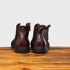 Back profile of H883 Calzoleria Toscana Liver High Top Benso Sneaker on top of a wooden table