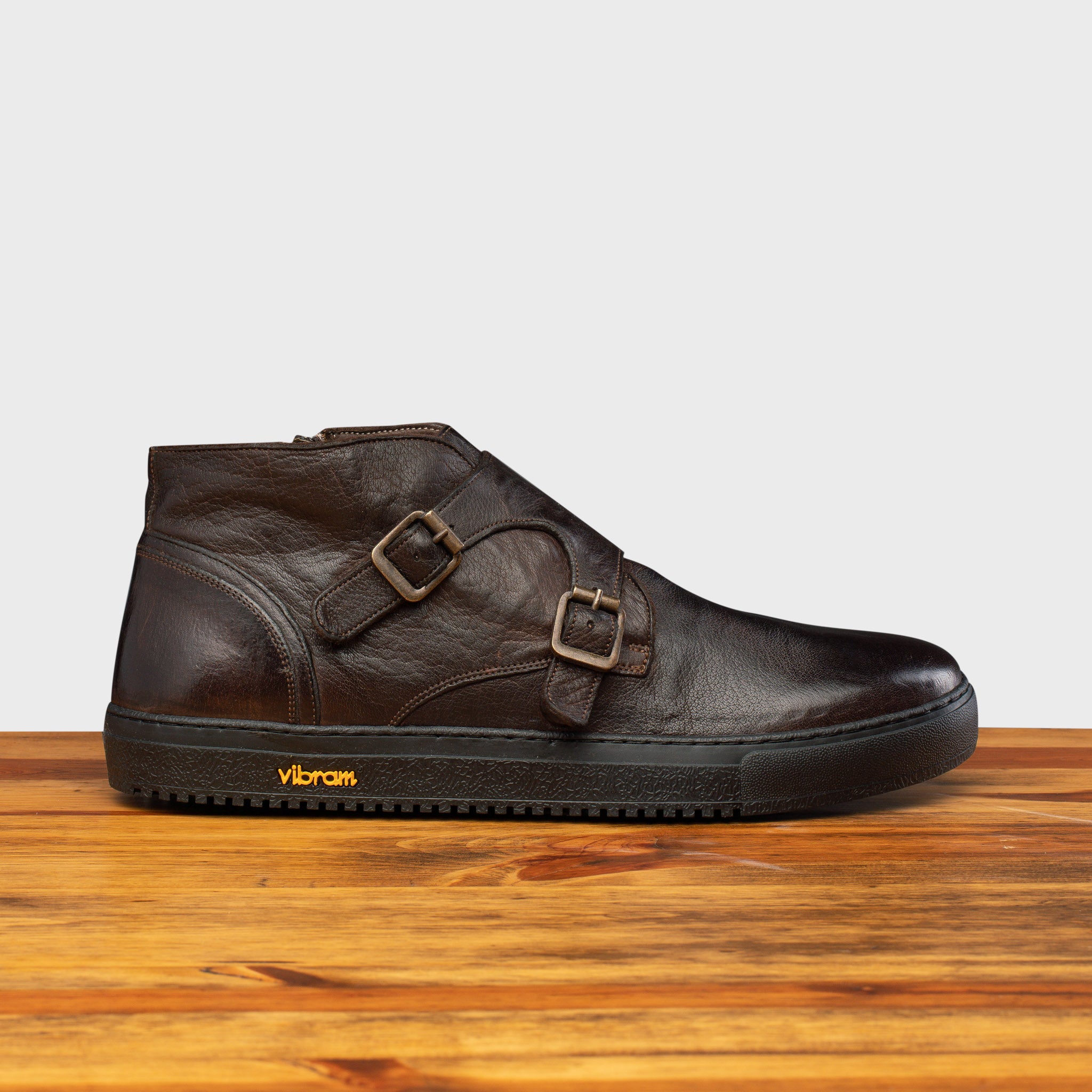 Side profile of H884 Calzoleria Toscana Dark Brown Dip-Dyed Double Strap Sneaker on top of a wooden table