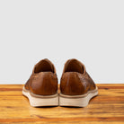 Back profile of Q399 Calzoleria Toscana Agos Wingtip Blucher on top of a wooden table