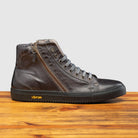 Side profile of Q555 Calzoleria Toscana Stone Dip-Dyed Buff Calf High Top on top of a wooden table