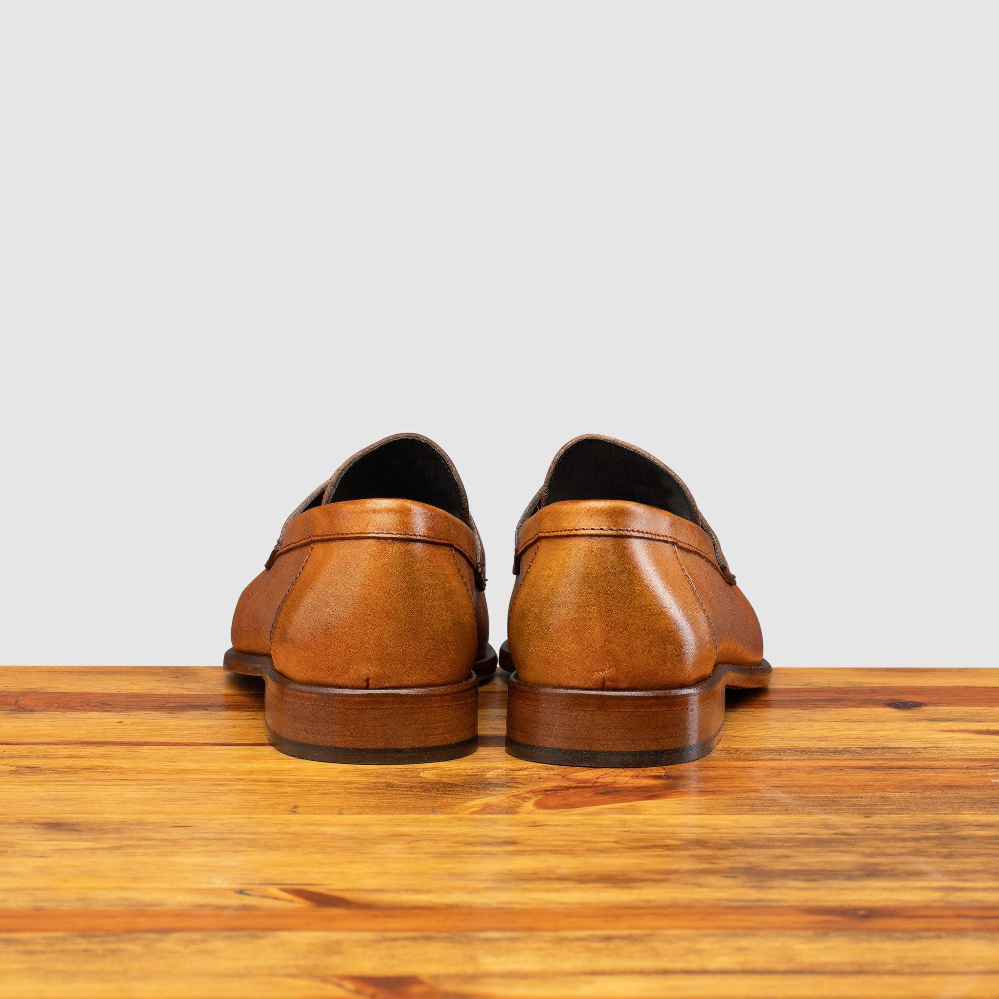 Back profile of Calzoleria Toscana Santor Collegiate Loafer on top of a wooden table