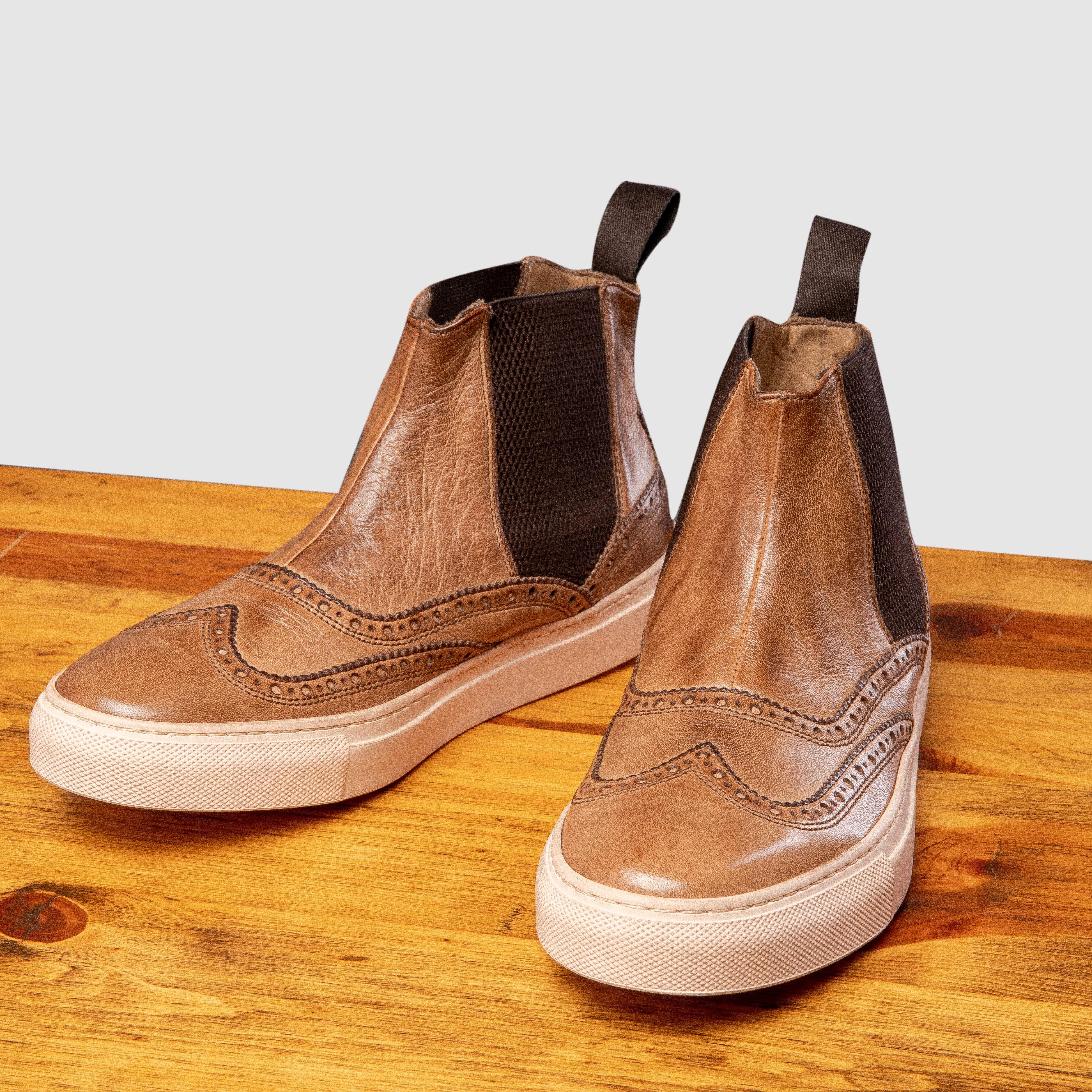 Pair of D741 Calzoleria Toscana Women's  Moor Ankle Sneaker on top of a wooden table