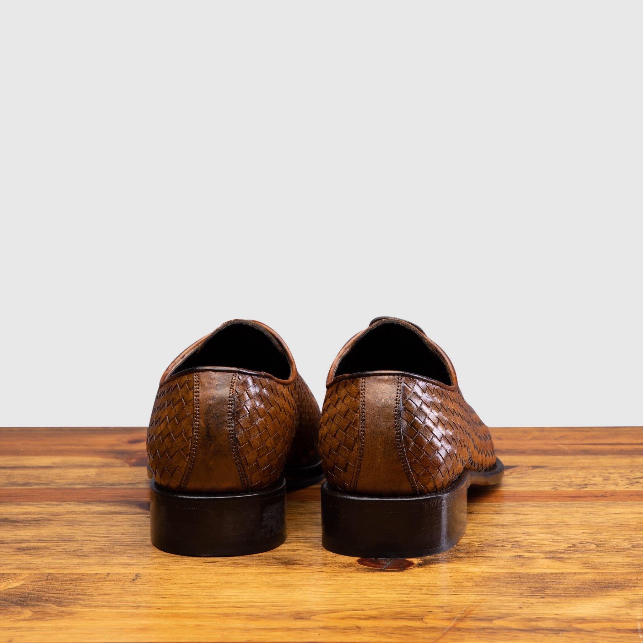 Back profile of 5373 Calzoleria Toscana Chestnut Woven Lace-Up on top of a wooden table