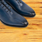 Close view of Ocean Blue leather dress shoe on a wooden surface