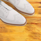A Close view of White shoe on a wooden surface
