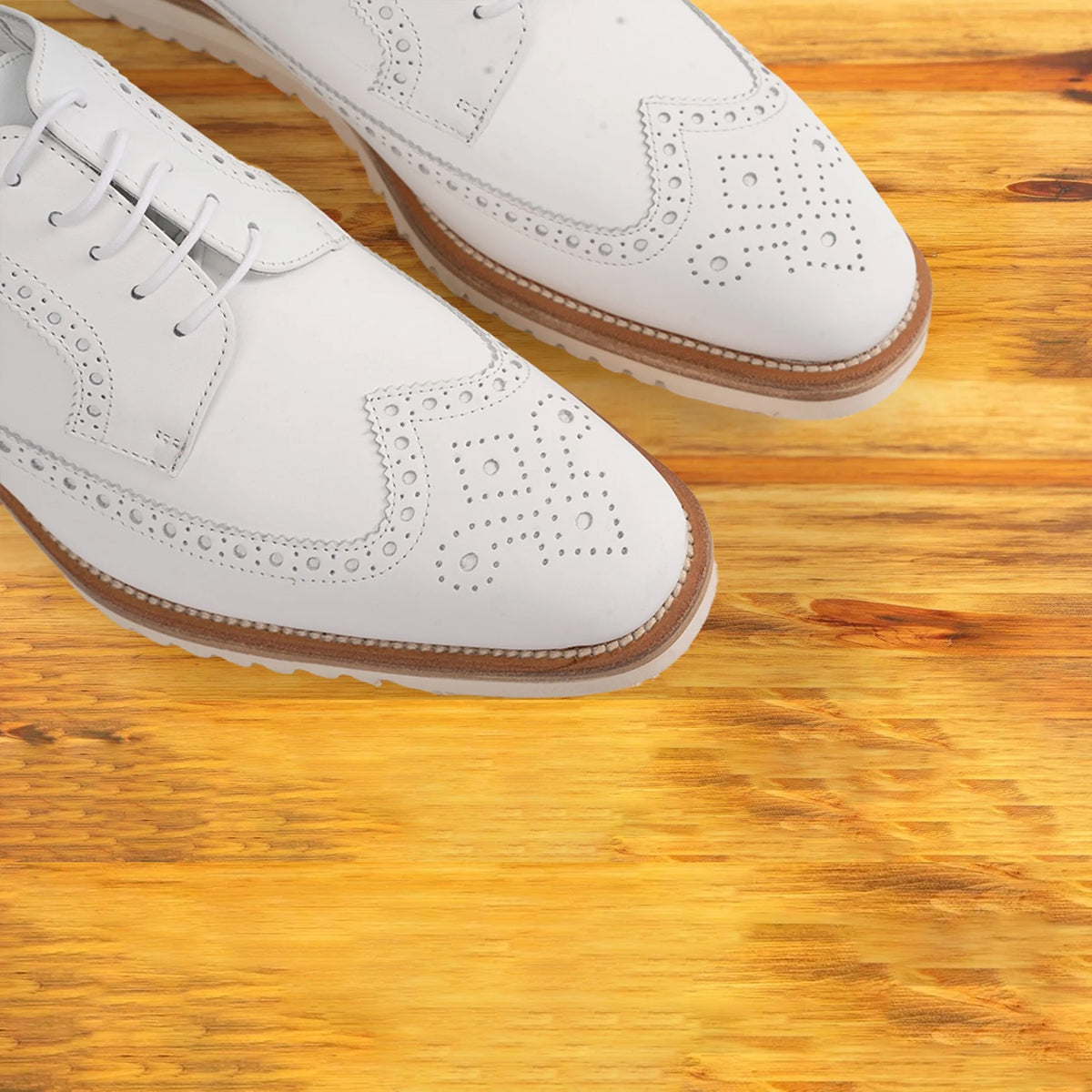 A Close view of White shoe on a wooden surface