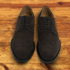 Dusty Brown suede dress shoe on a wooden surface