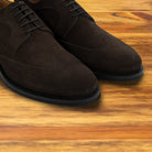 Dusty Brown suede wingtip shoes, close-up front view of the pair showing the brogue detailing, wingtip toe cap