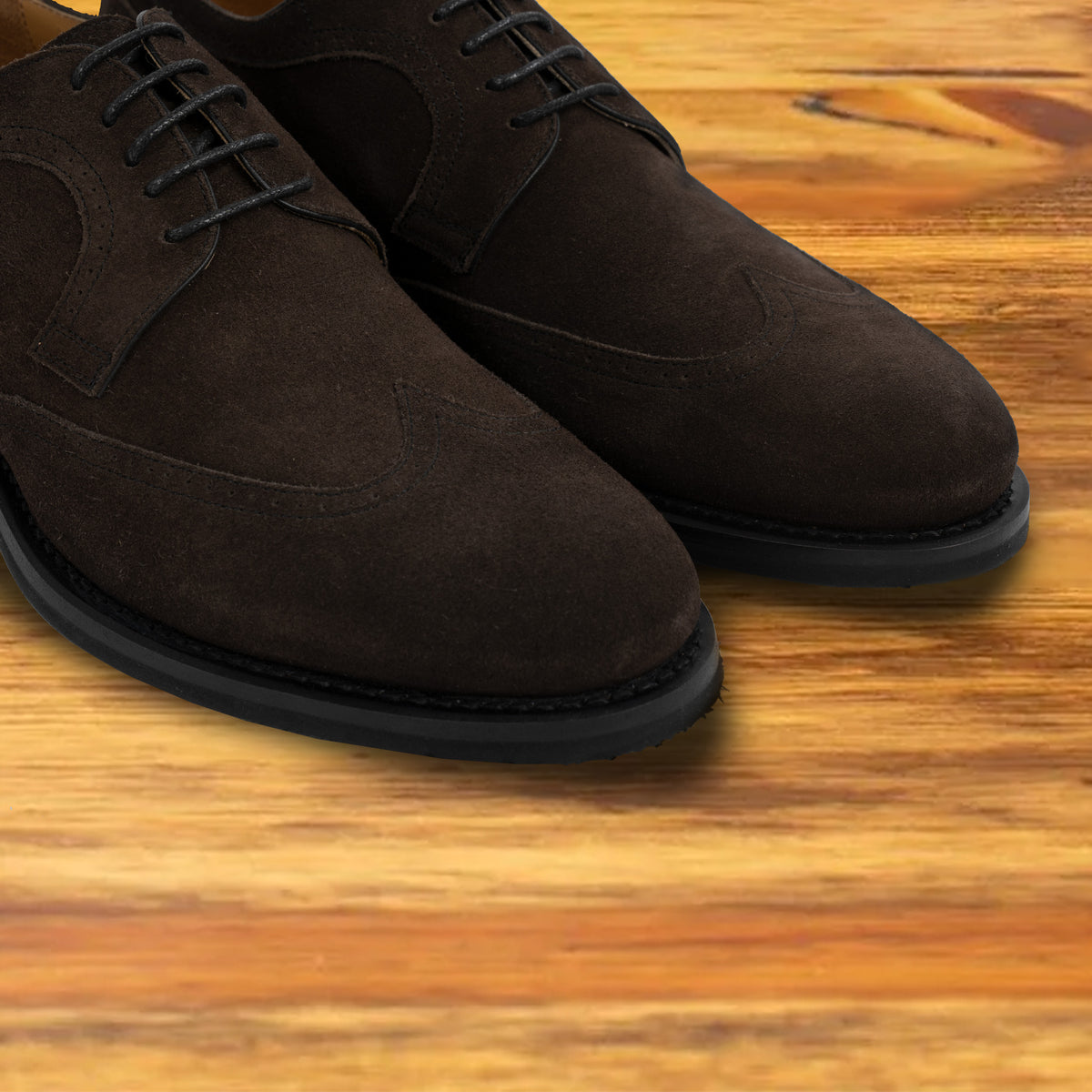 Dusty Brown suede wingtip shoes, close-up front view of the pair showing the brogue detailing, wingtip toe cap