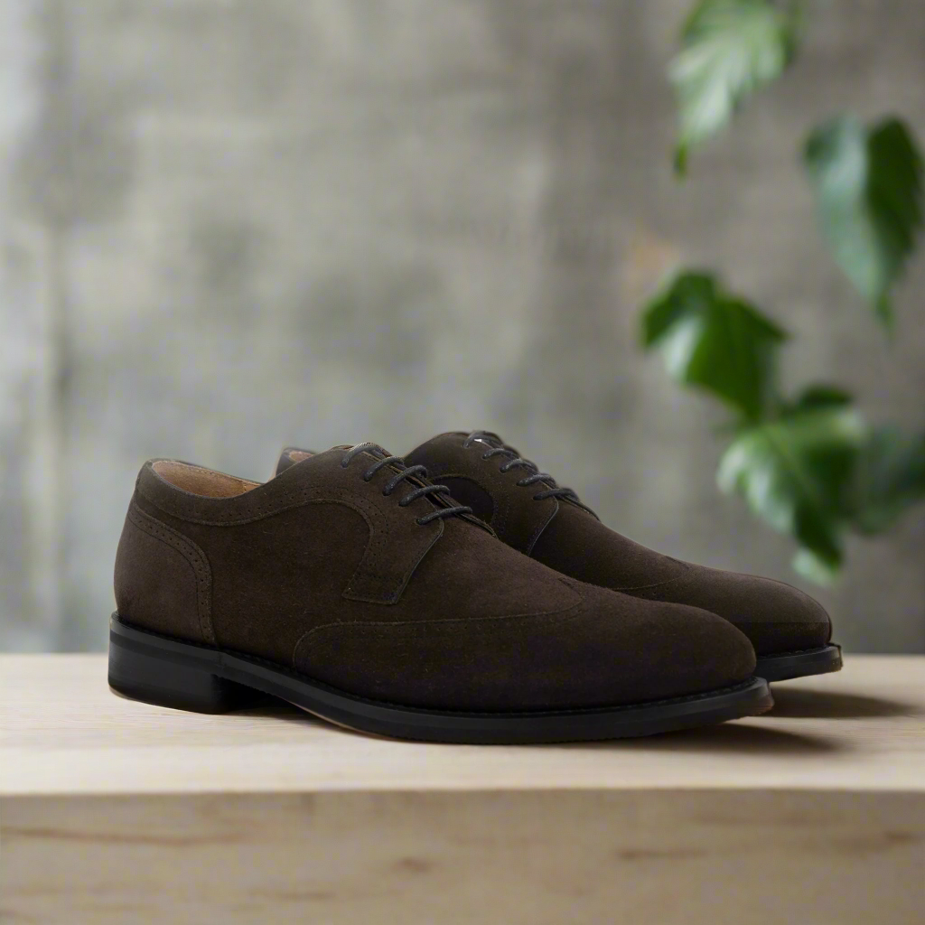 A Pair of Dusty Brown suede dress shoe on a wooden surface