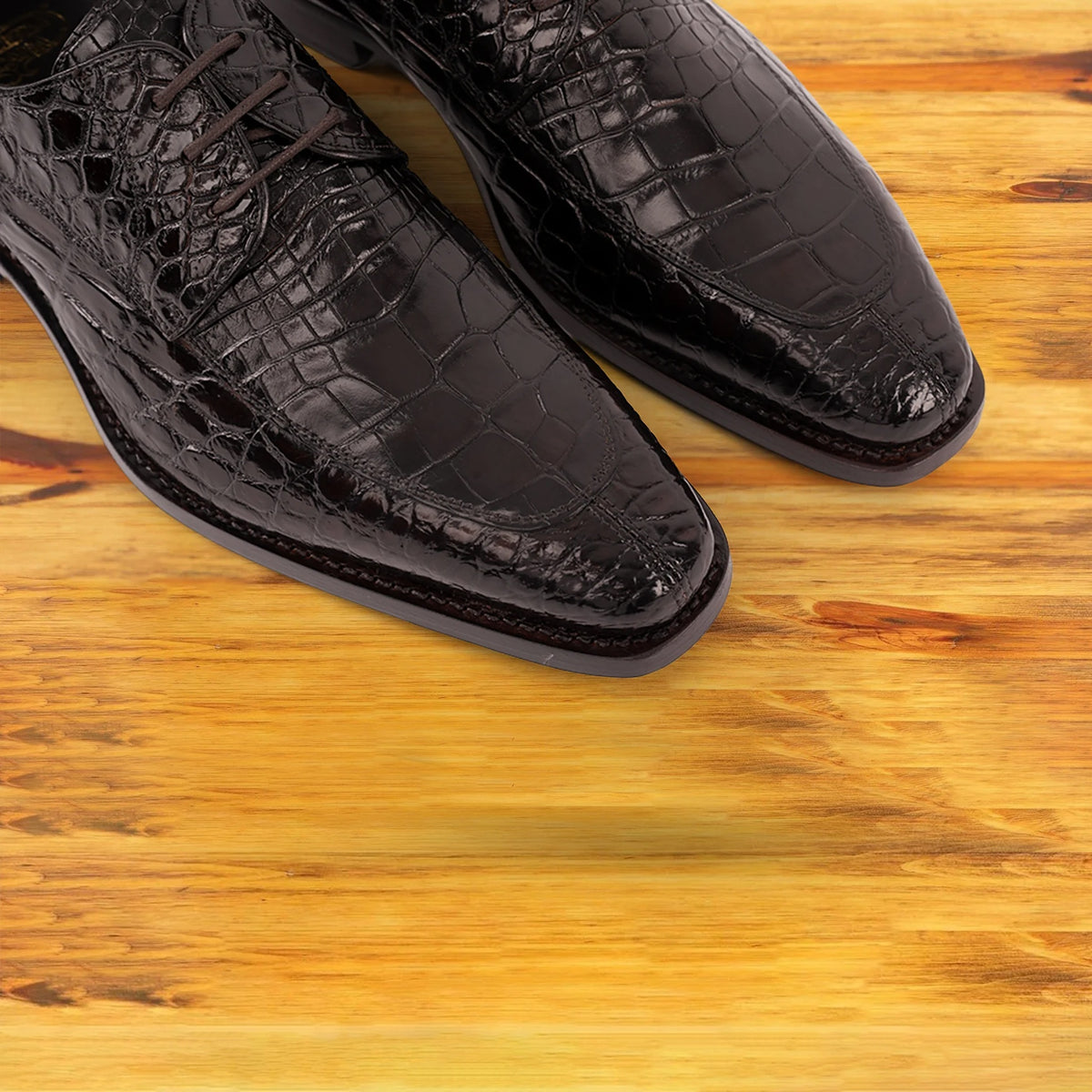 Espress Brown crocodile shoe on a wooden surface