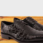Espresso Brown crocodile shoe on a wooden surface