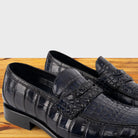 A Pair of Blue leather loafer on a wooden surface