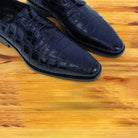 Midnight Blue crocodile shoe on a wooden surface