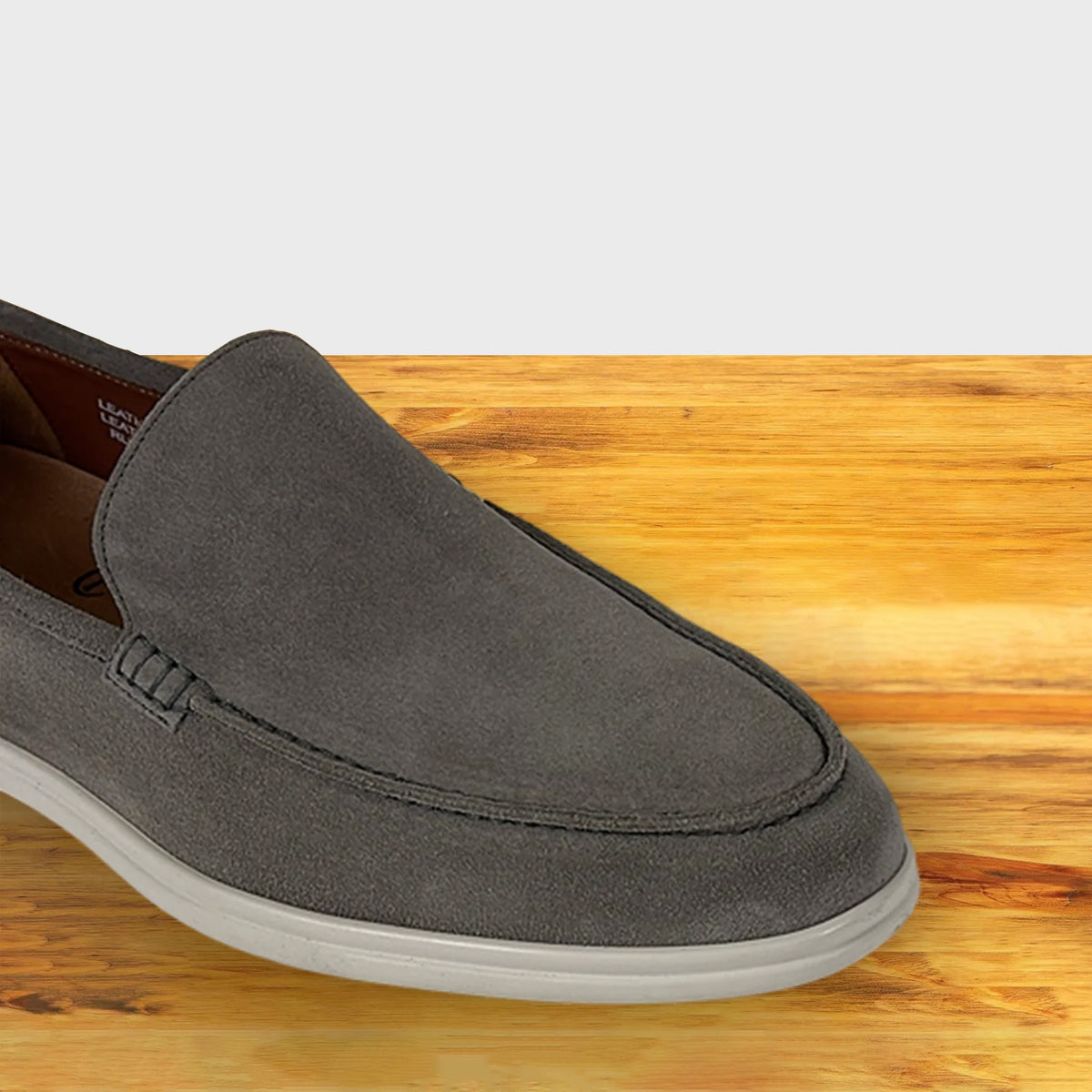 Gray loafer shoe on a wooden surface
