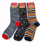 Three pairs of patterned crew socks displayed together on a white background. The left pair has gray and white stripes with a red toe and heel.