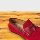 Red loafer shoe on a wooden surface