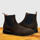 Dusty Brown suede Chelsea boot on a wooden surface