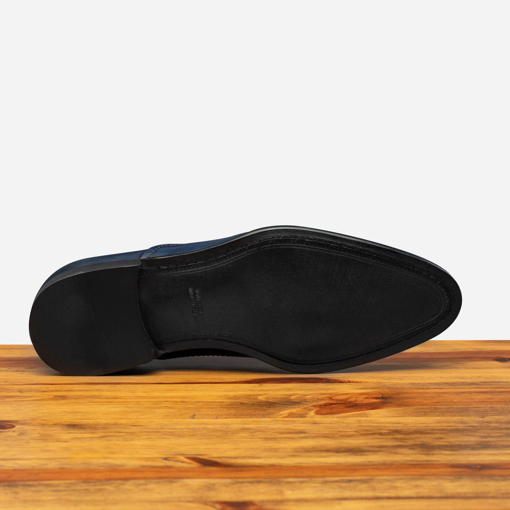 Full leather outsole of the 2361 Calzoleria Toscana Blue Cayenne Calf Cap-Toe on top of a wooden table