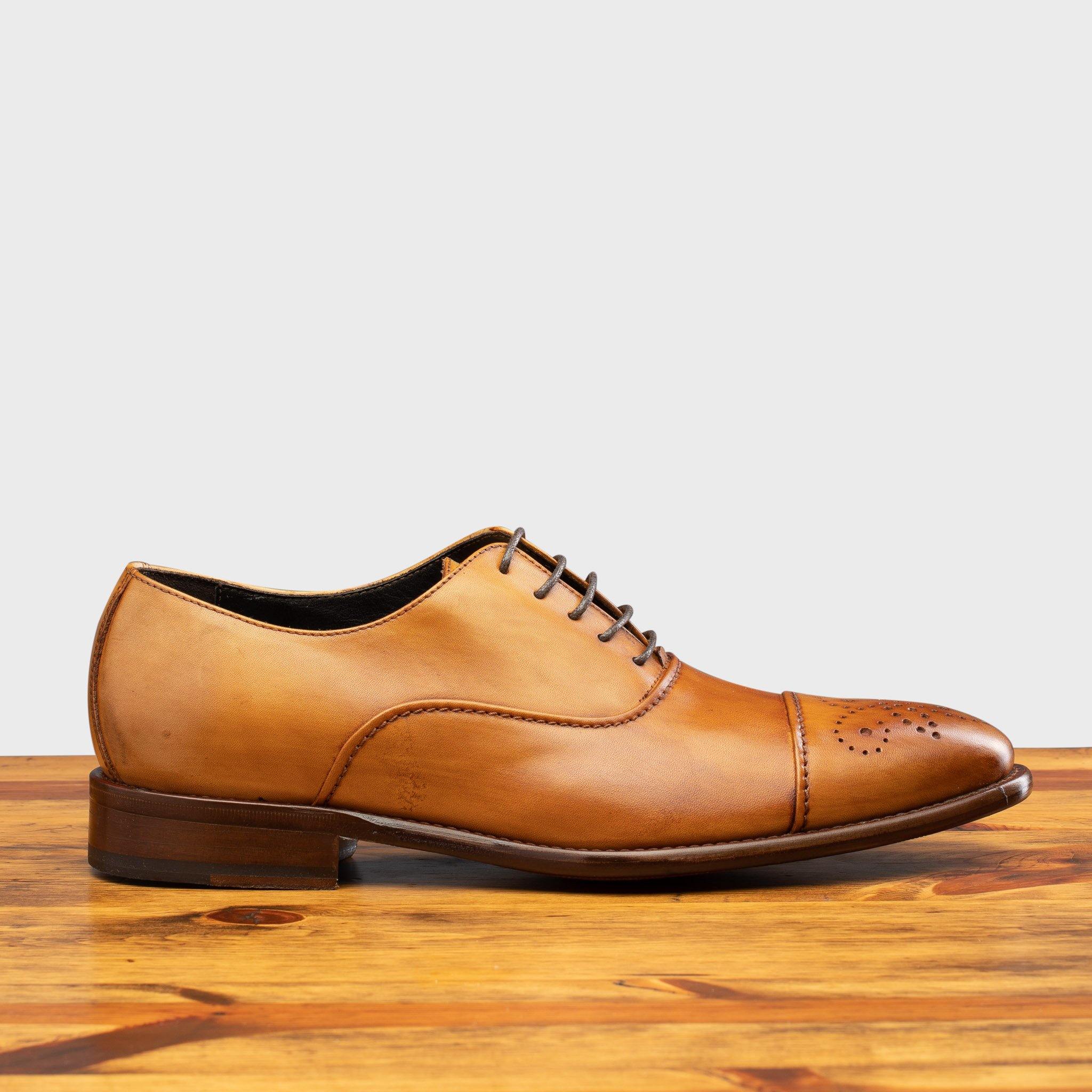 Side profile of the 2361 Calzoleria Toscana Dark Caramel  Cayenne Calf Cap-Toe on top of a wooden table